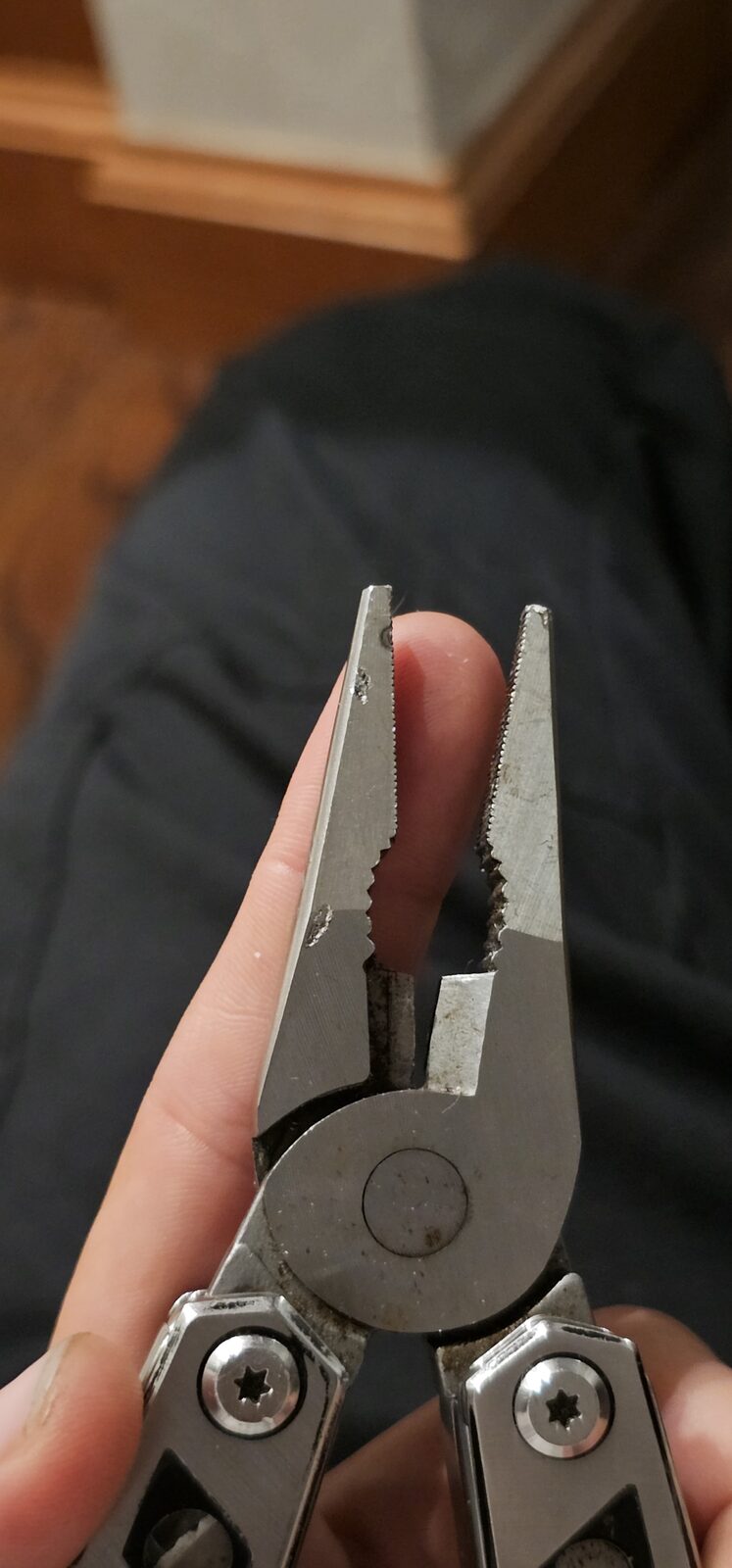 Close-up of the pliers on Lyn's multi-tool showing a small chip in the jaw after two years of heavy marine-mechanic work